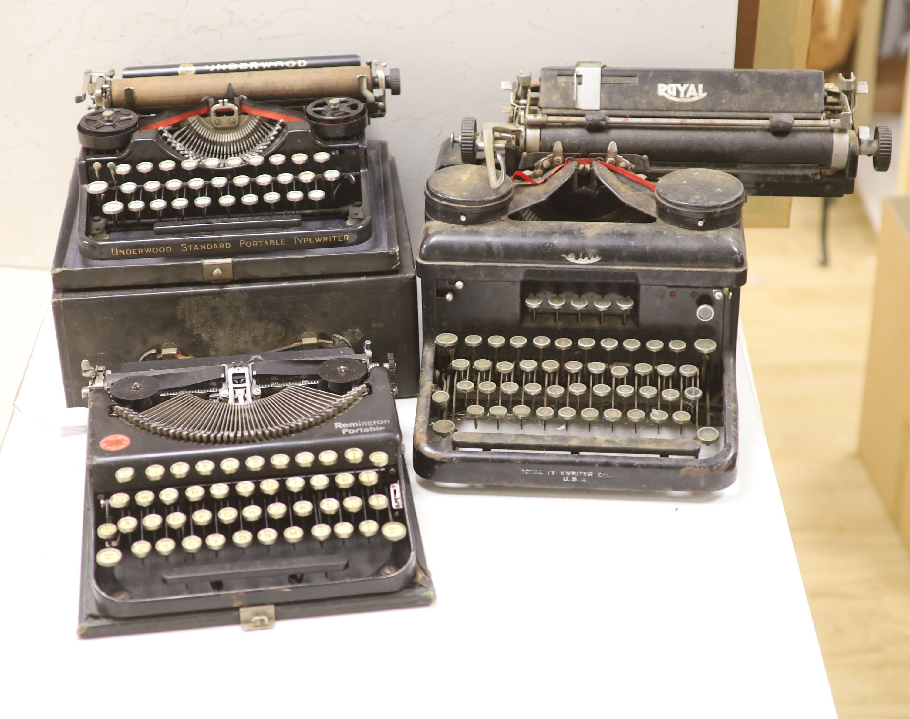 Three vintage typewriters: Underwood Standard portable, Remington Portable and Royal Typewriter Company